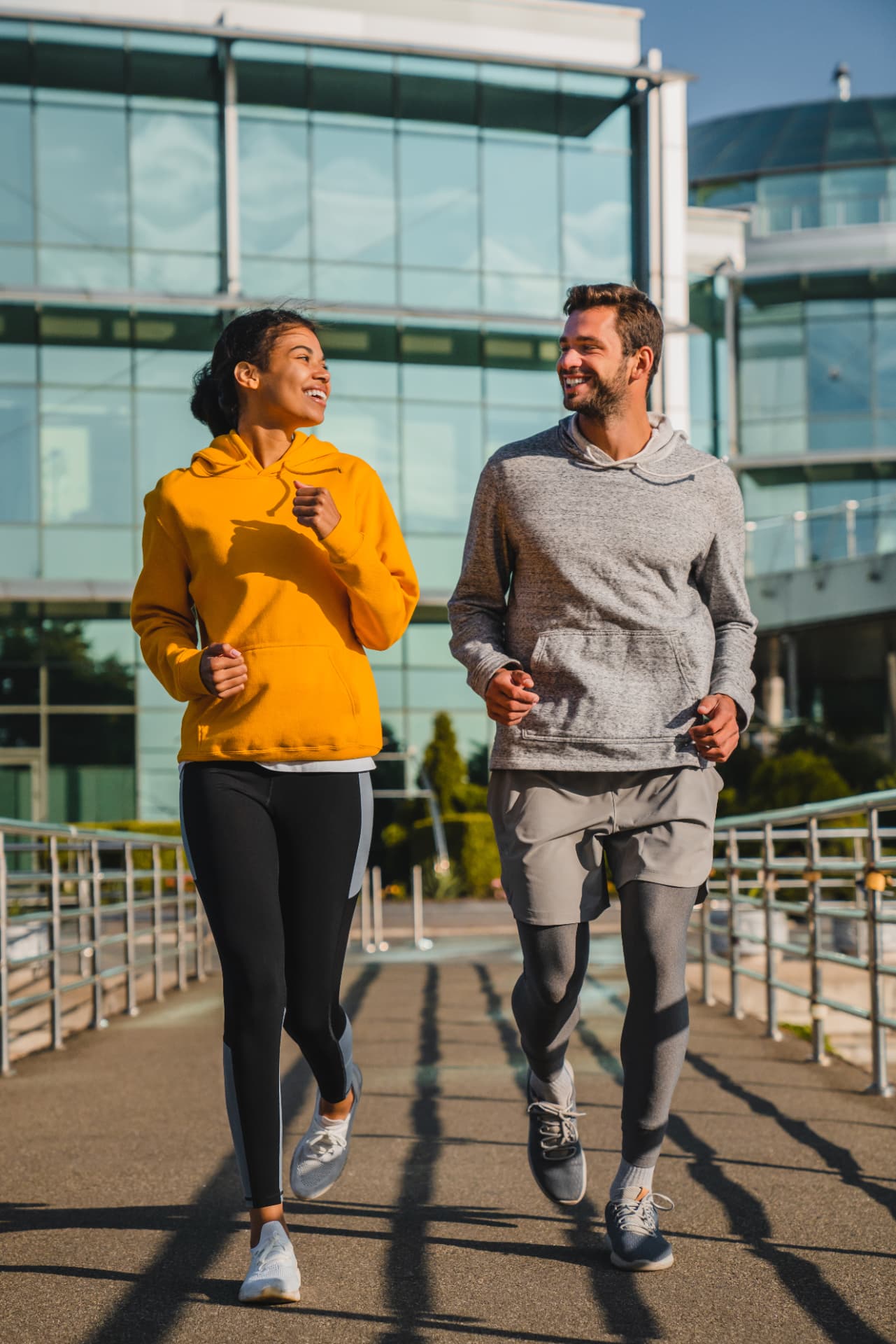 Couple jogging together outdoors in morning light