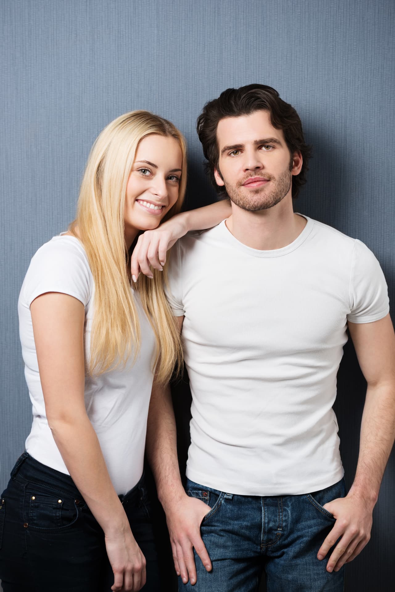 Smiling couple in white t-shirts standing together