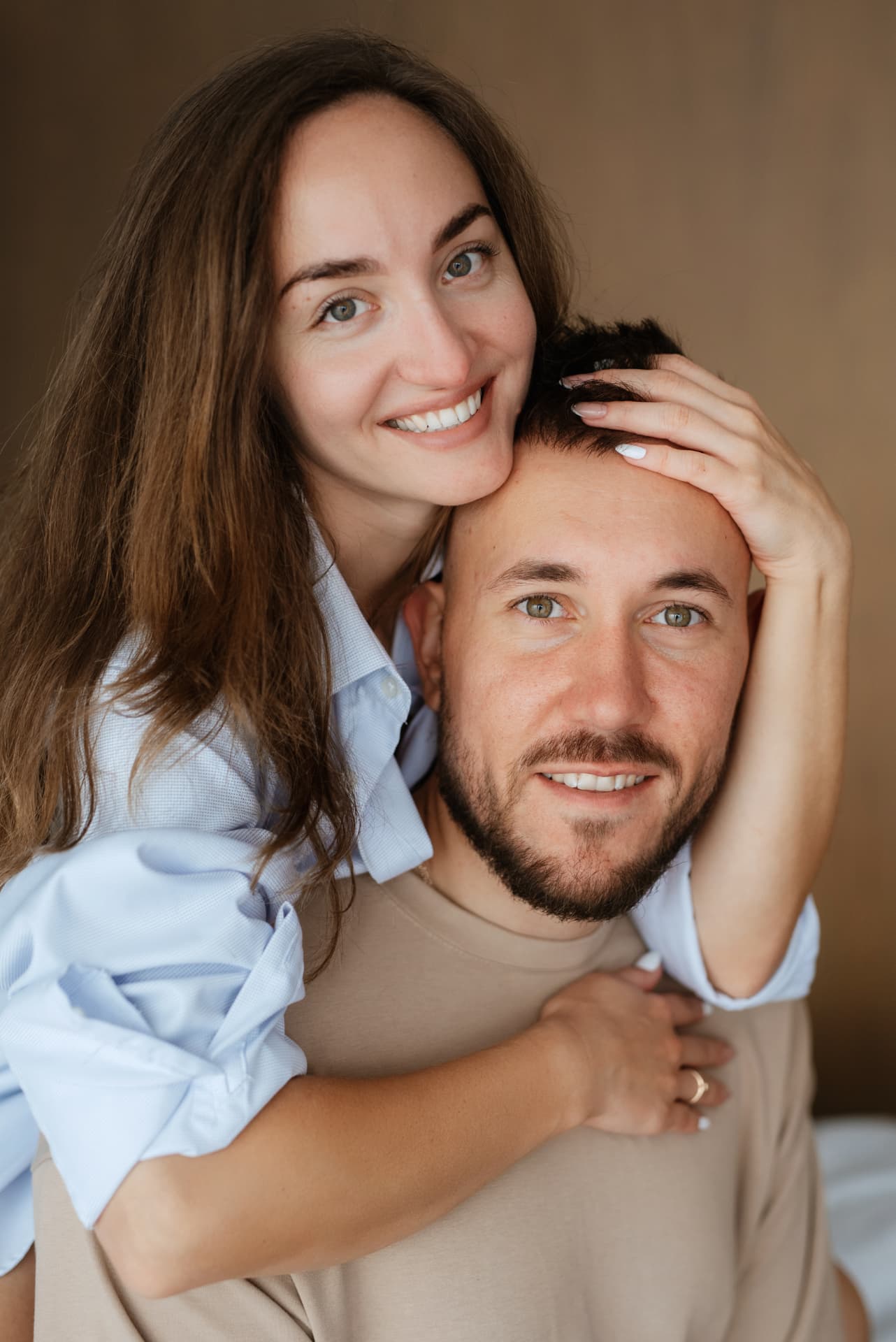 Couple embracing at home in soft light