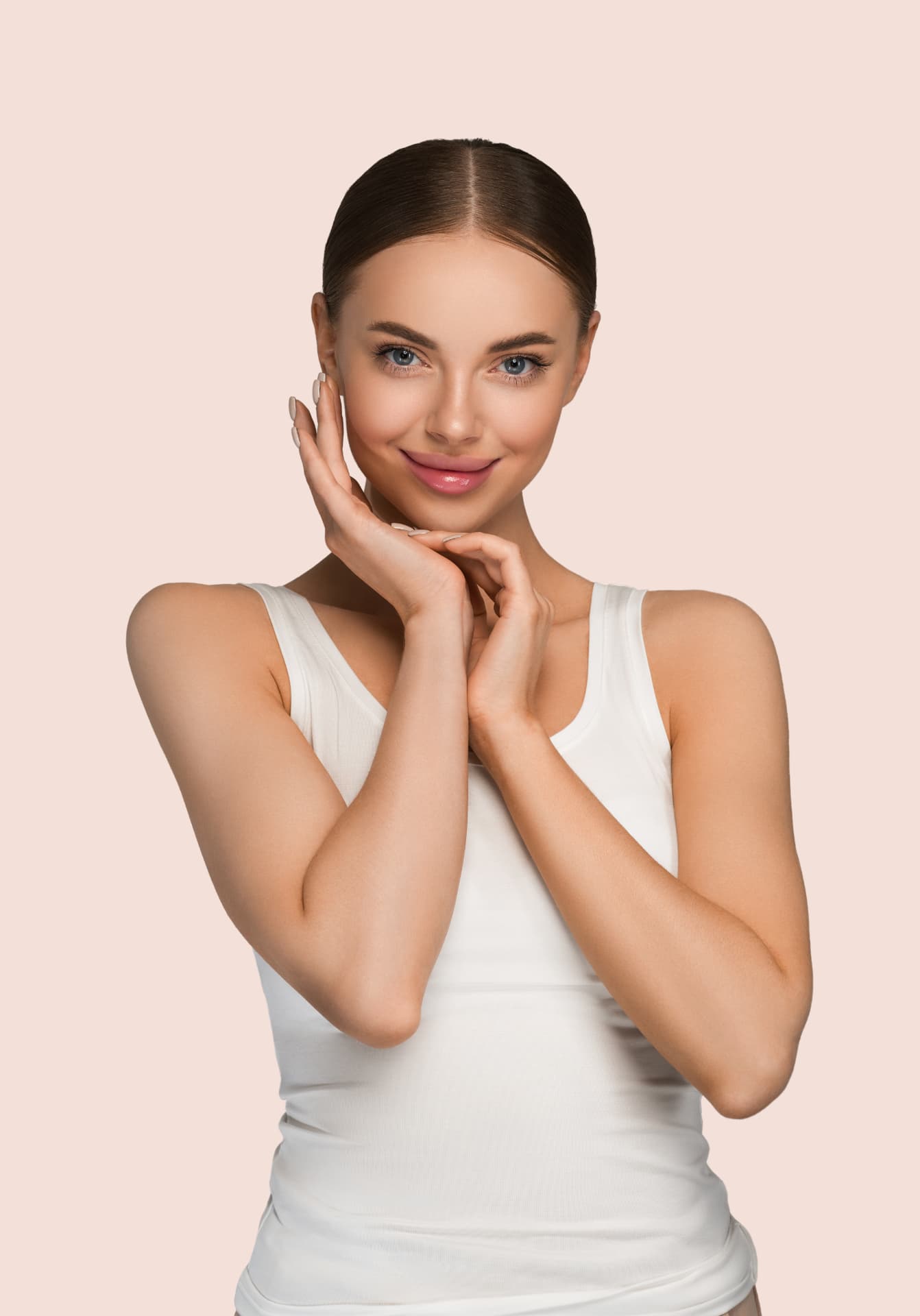 Young woman with natural, even-toned skin resting her hands beneath her chin