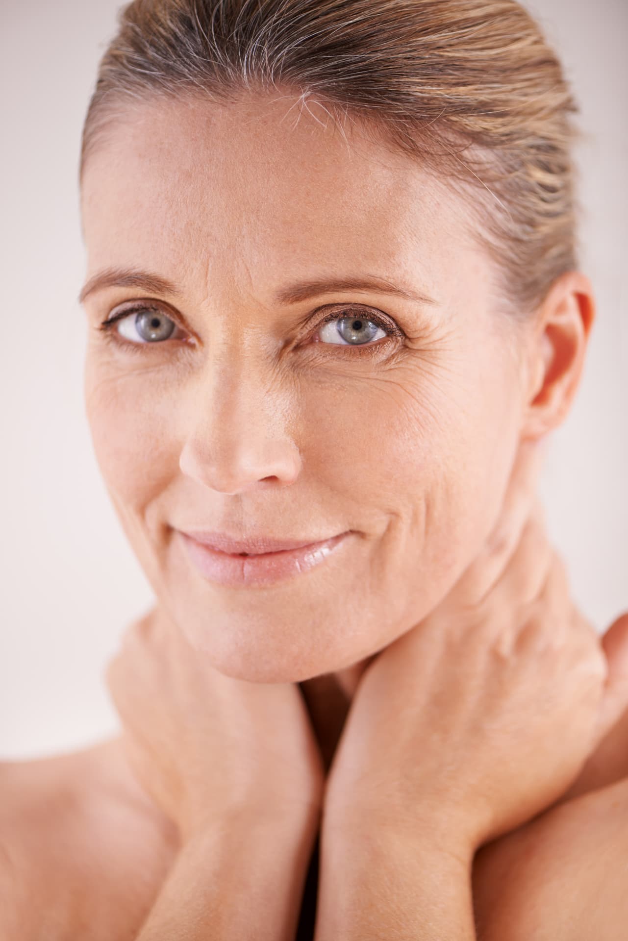 Close-up portrait of a smiling woman with radiant skin