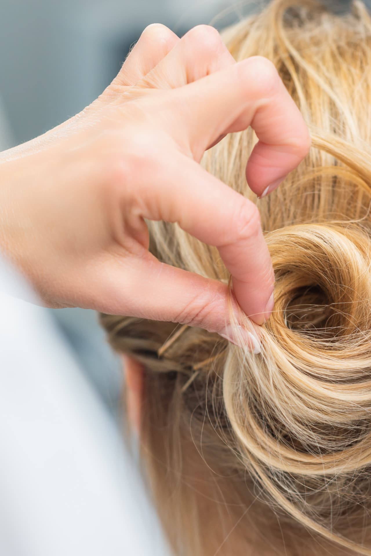 Close-up of healthy blonde hair being styled