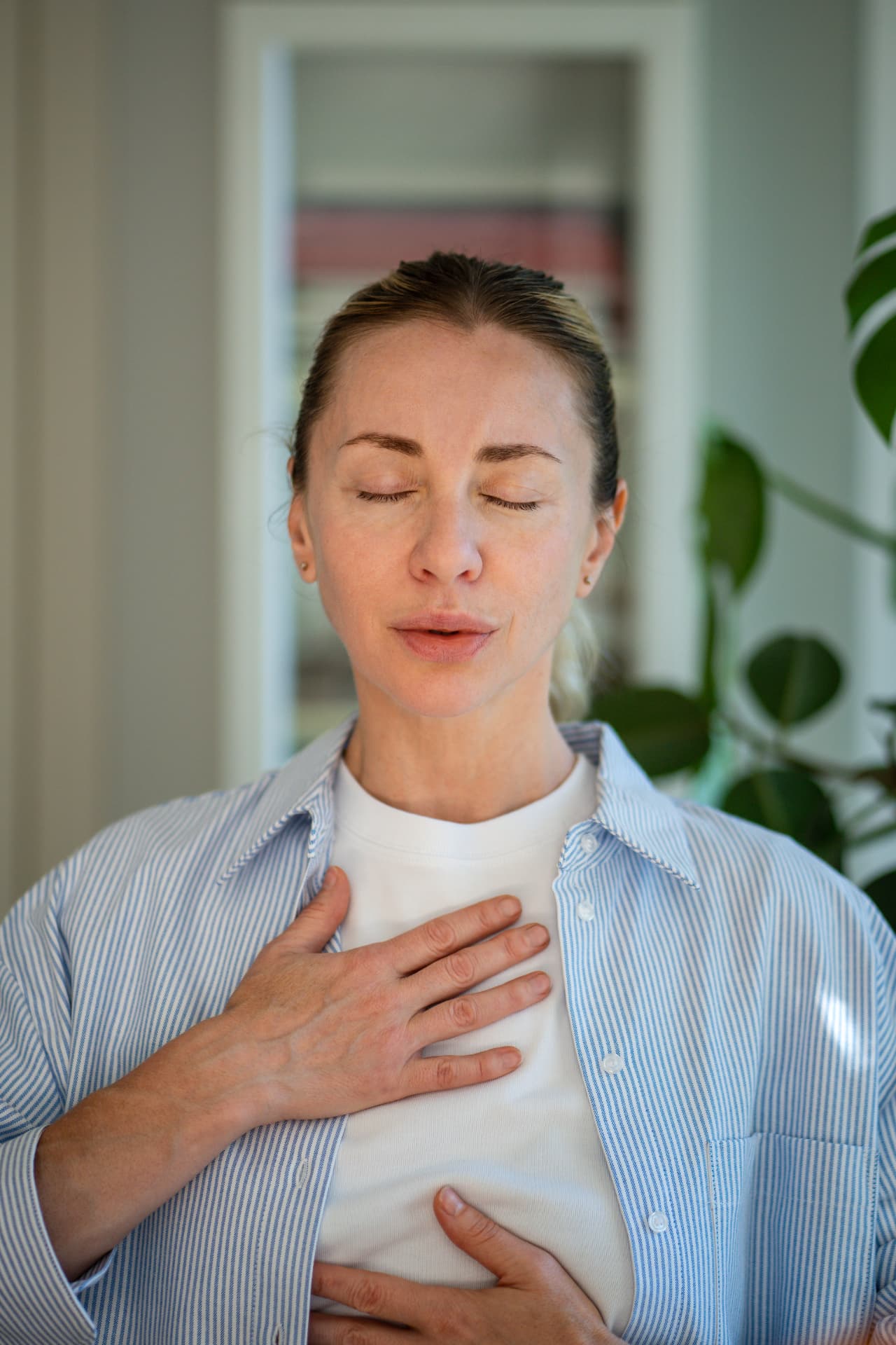 Woman breathing calmly with her hands on her chest